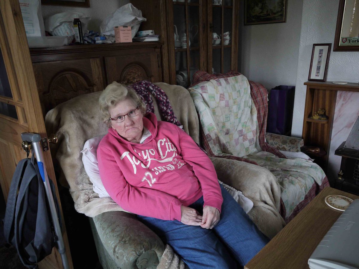 Ann in her living room in the small bungalow she shares with Barry who supports her