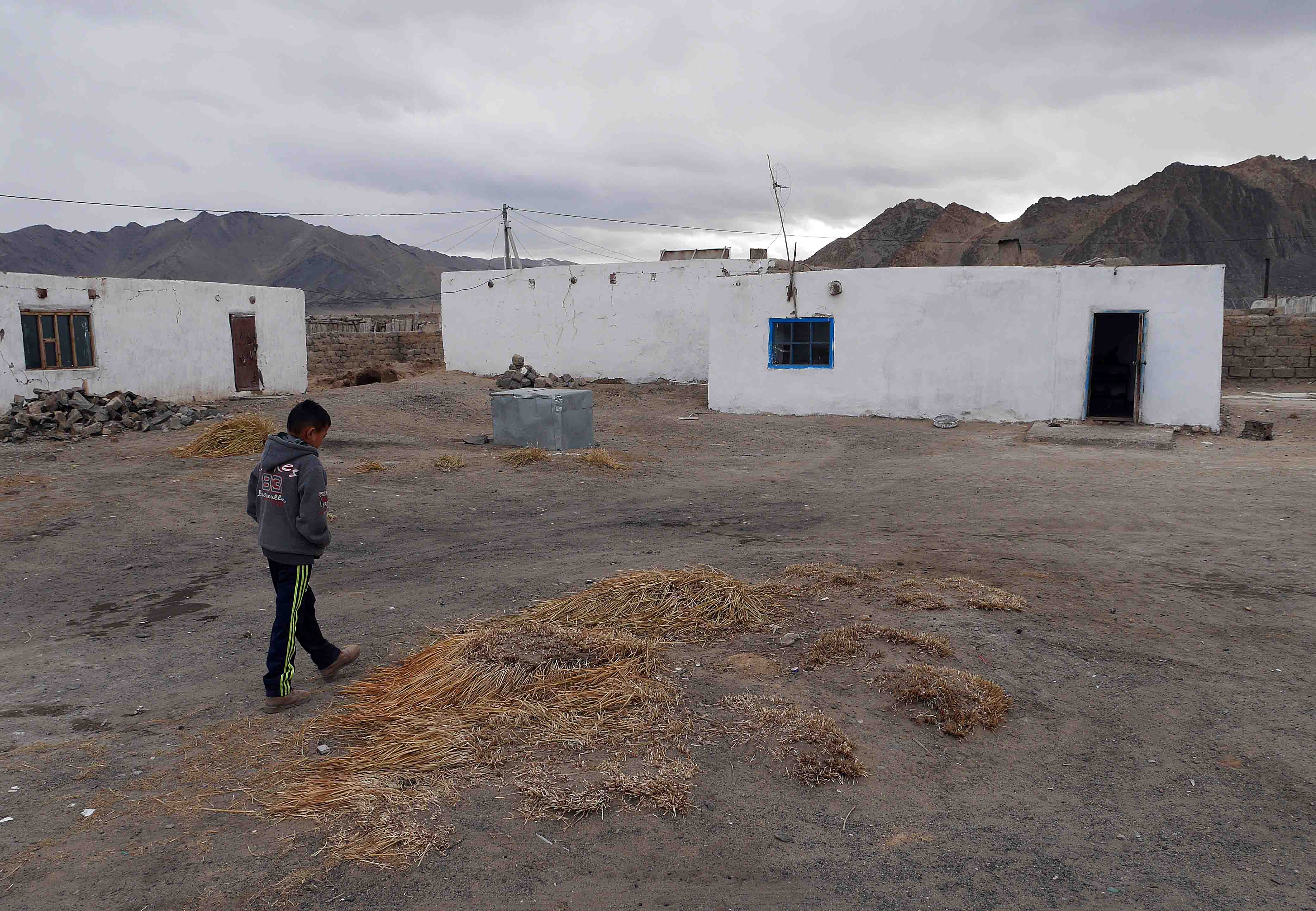 Oralbek walking towards his home on the outskirts of Ulgii, western Mongolia.