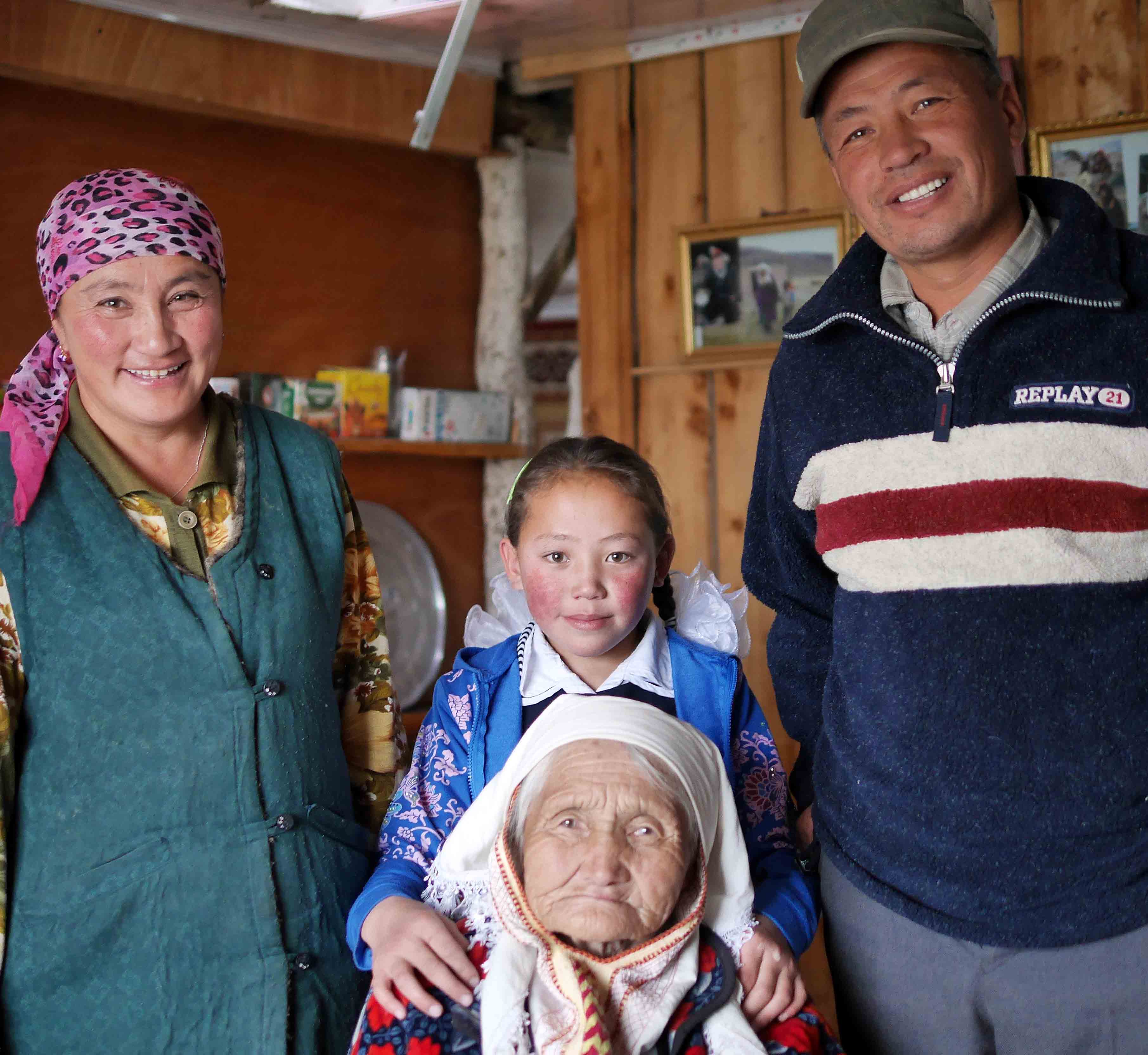 Sapargul (mother), Anikei (grandmother), Tilek (father), and Akerke, at home.