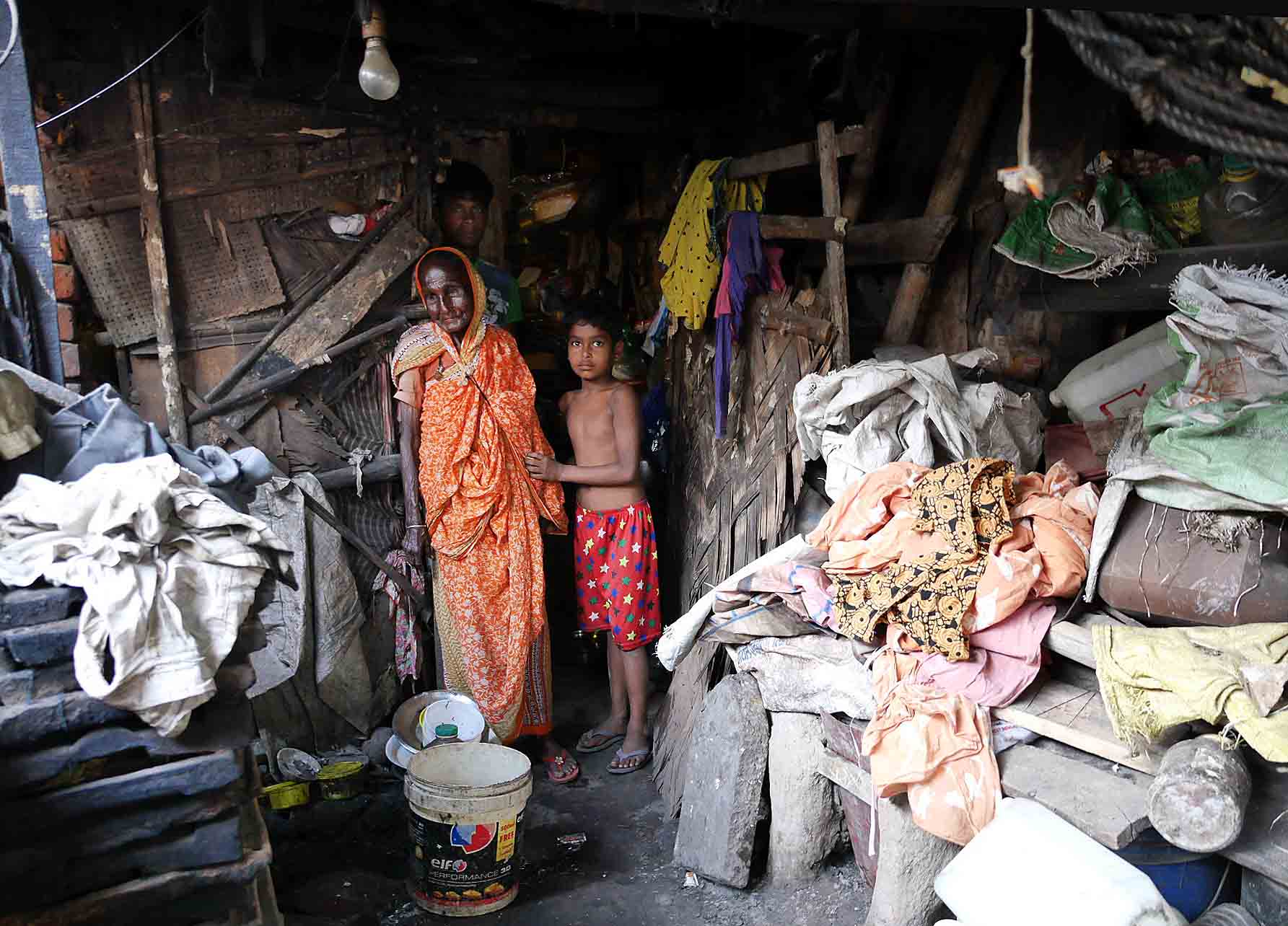 Sabu Jan Bibi at home in her son’s house with two grandchildren.