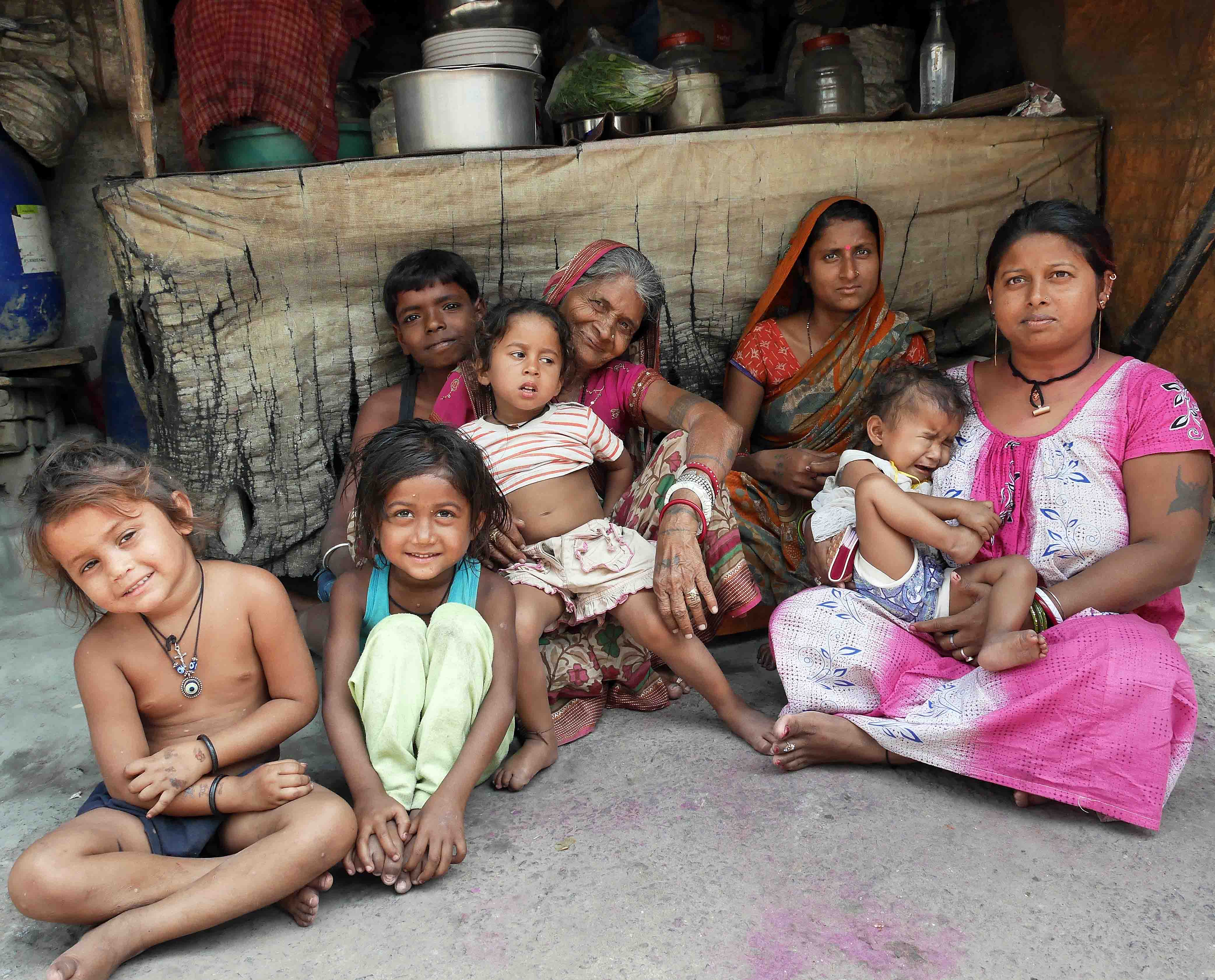 Jyoti at home with her extended family and neighbours.